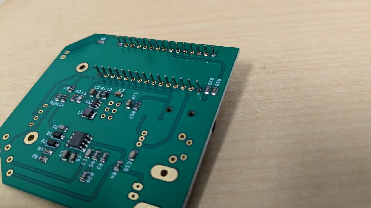 The back of the board, with the tips of the Arduino's pins soldered