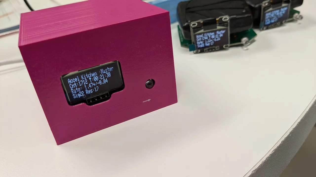 A v1 in a magenta case, with the OLED visible through the window showing Cnt and Rate