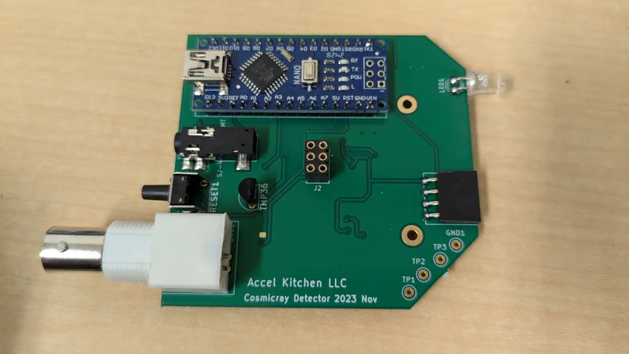 The finished v1 main board. On a green board are fitted an Arduino Nano, a white BNC connector, a jack, an LED, a reset switch, a temperature sensor, a 2 × 3-pin socket, a 4-pin socket for the OLED and test points