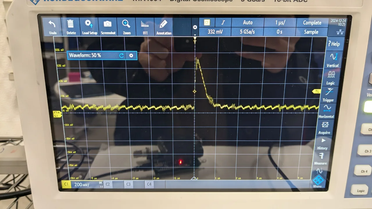 An oscilloscope screen showing a single short pulse