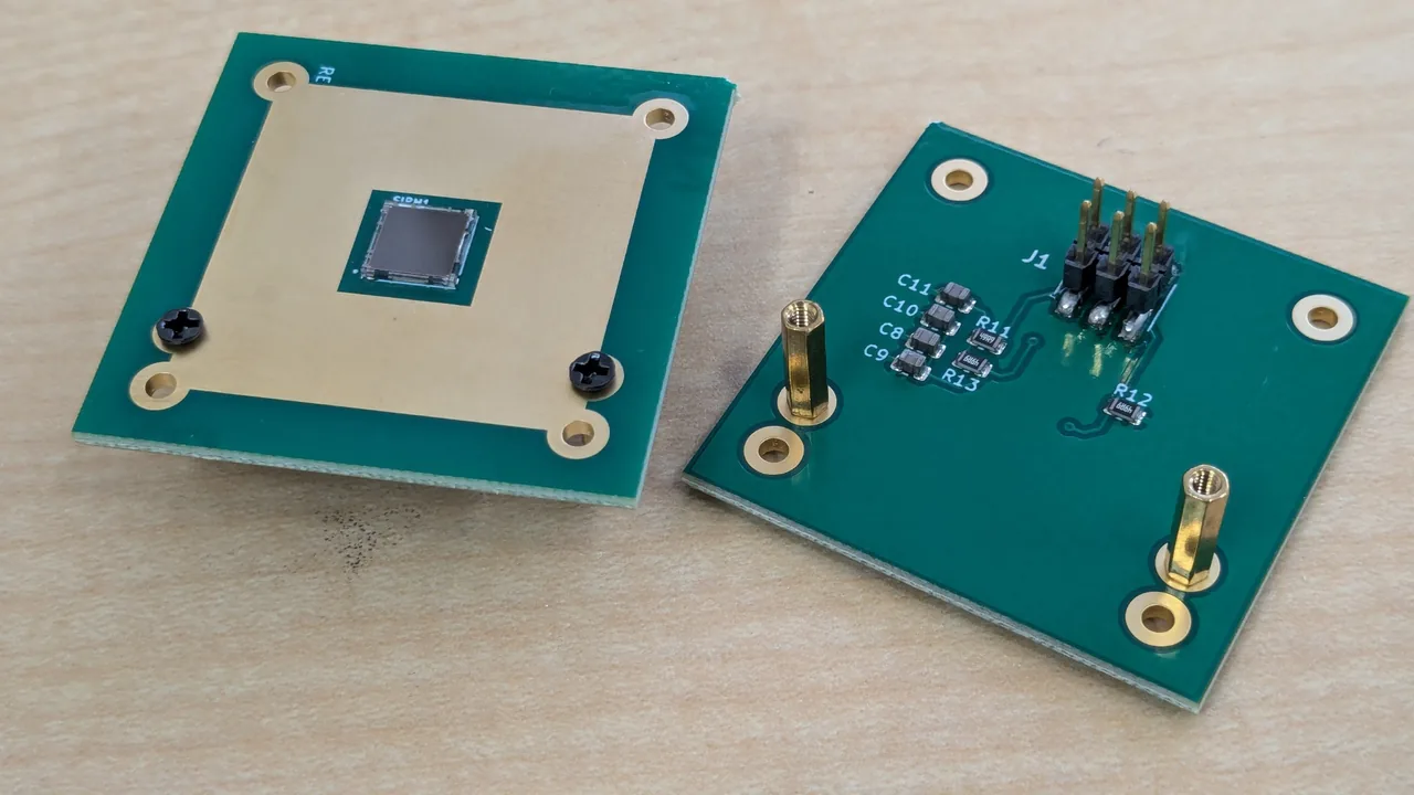 Two SiPM boards. The left shows the side with the SiPM; the right shows the side with the 6-pin connector and two spacers fitted
