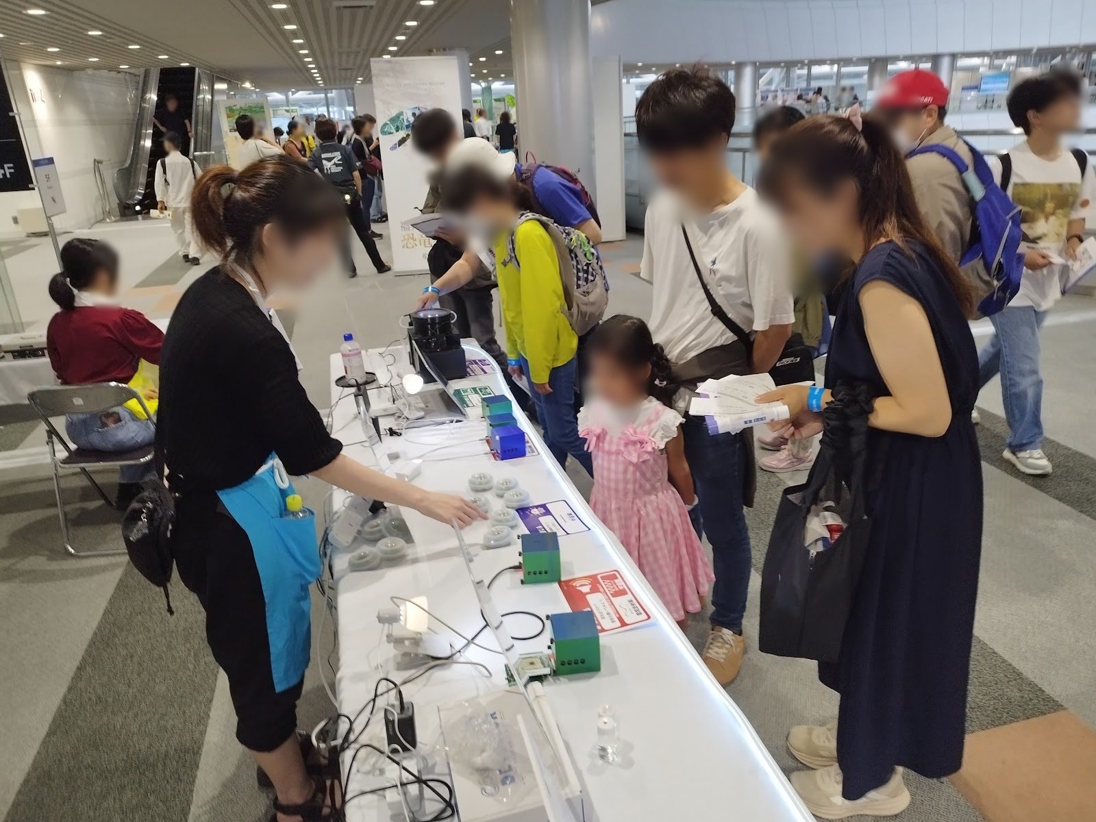 A family trying the devices with an explainer guiding them