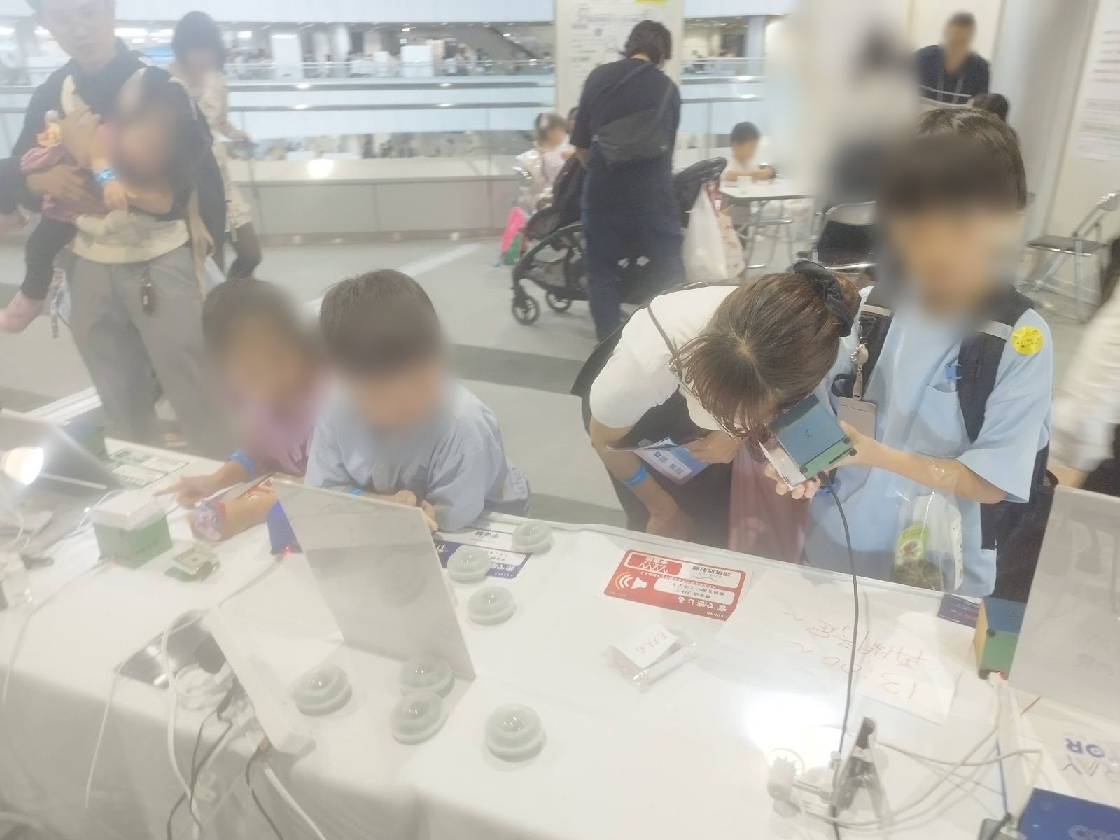 Children watching the devices on the table intently