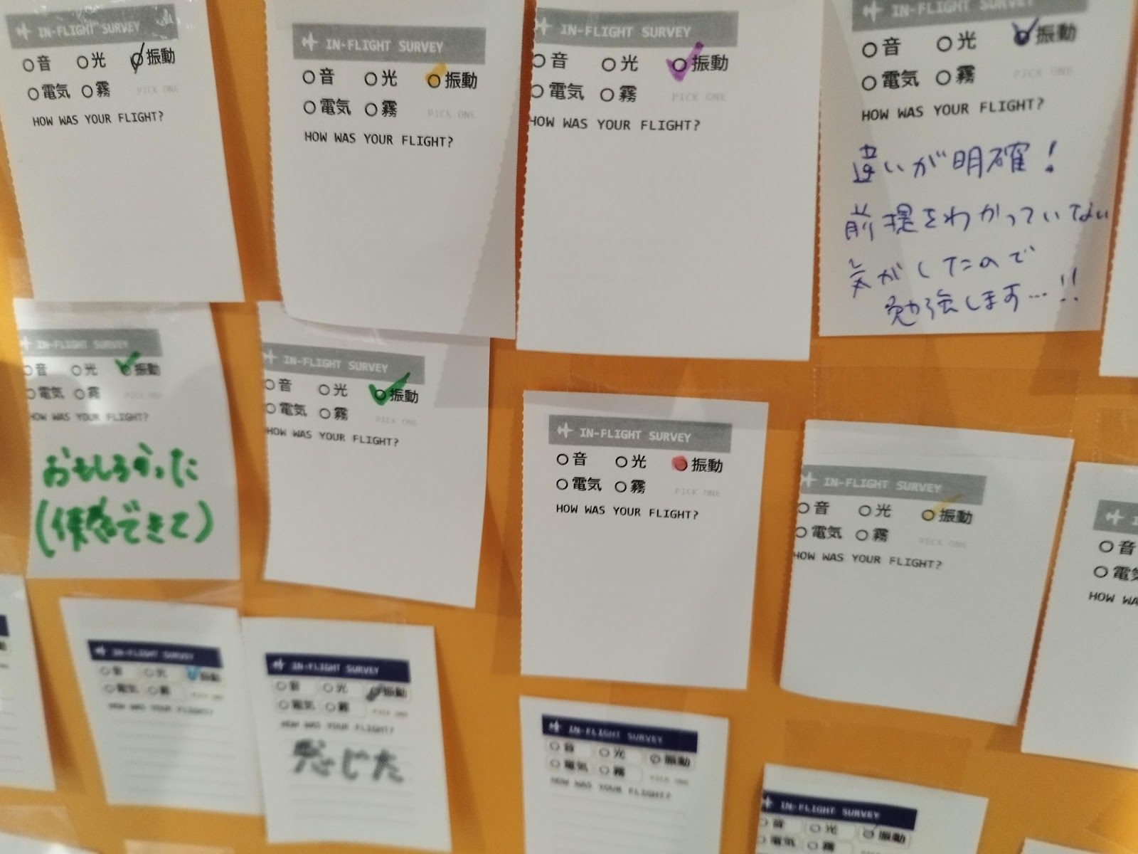 Stubs pinned to the orange vibration board, with handwritten comments